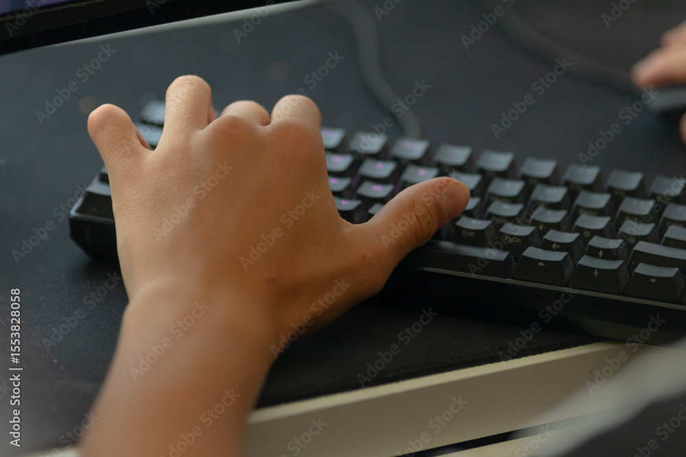 Poster a person is using their hand to type on a sleek black keyboard, demonstrating the interaction with t