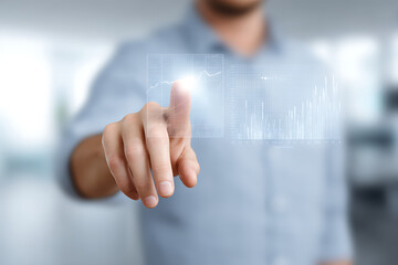 Businessman Using Touchscreen Interface with Financial Data Charts – Modern Technology Concept
