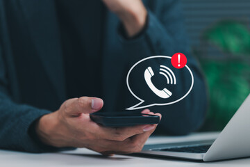 Phone Scam Alert and Warning Notification Concept. A person holding smartphone displaying call icon with alert symbol, representing scam call warnings, fraud awareness, digital communication threats,