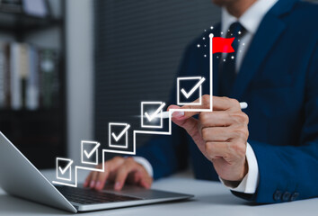 Business success and goal achievement steps. Businessman drawing checkmarks on staircase steps toward achieving goals, ending with red flag success marker. planning, progress, goal setting, milestone,