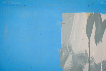 Blue wall background with part of urban graffiti painting