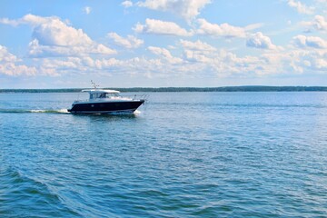 A motorboat rushes across the water. Seascape.