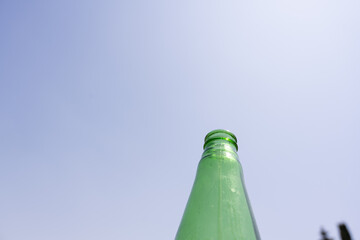 Green Bottle Against a Clear Blue Sky

