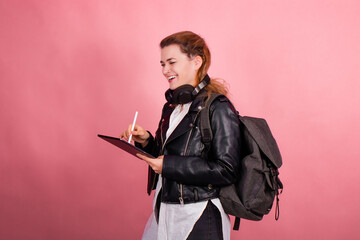 Woman with headphones, listening to music, fashion model in studio posing, music genre, smiling, rock, metal music , tablet