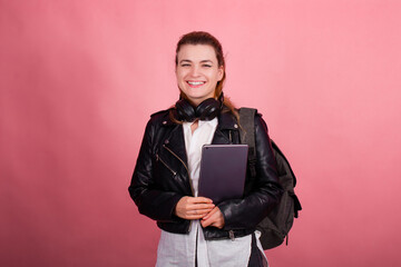 Woman with headphones, listening to music, fashion model in studio posing, music genre, smiling, rock, metal music , tablet