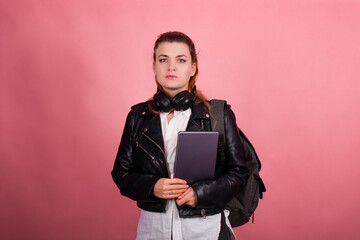 Woman with headphones, listening to music, fashion model in studio posing, music genre, smiling, rock, metal music , tablet