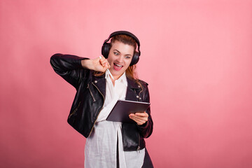Woman with headphones, listening to music, fashion model in studio posing, music genre, smiling,...