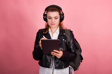 Woman with headphones, listening to music, fashion model in studio posing, music genre, smiling,...