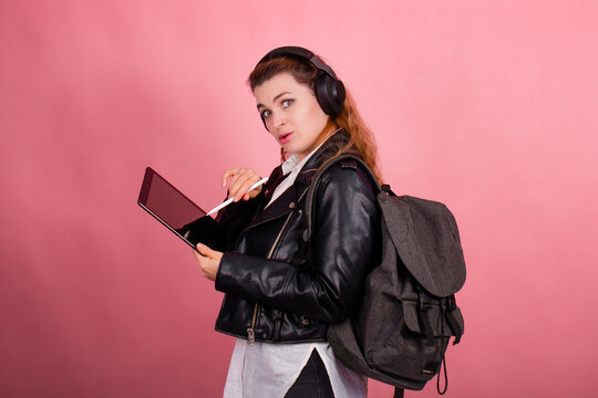 Woman with headphones, listening to music, fashion model in studio posing, music genre, smiling, rock, metal music , tablet