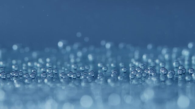Close up of resting gas bubbles in water on blue backround