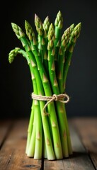 Fresh asparagus bunch tied with twine on a wooden table , fresh produce, food, twine