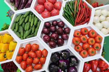 Fresh and appetizing tomatoes,cucumber, onion, eggplant,pepper presented at a vegetable fair.