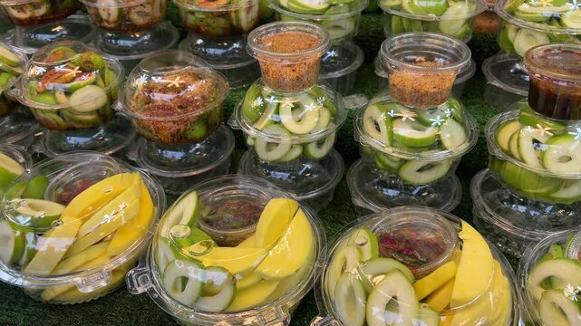 Green Mango with chili powder and salt on wooden table, Sliced green mango, Organic Fresh Mango, Indian Raw Mango Pickle preparation, Kaccha aam ingredients , Kerala Mangos, Text space, copy space