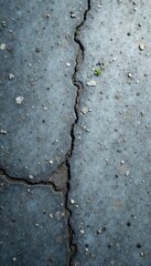 Obraz premium Cold industrial concrete texture background with scattered gray pebbles and subtle cracks, cracks, worn