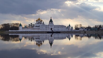 Early spring in Russia. Holy Trinity Ipatievsky Monastery, sun rays and clouds reflected in the...