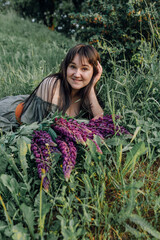 In combination with nature and flowers, harmony with oneself, happy moments, peace and balance. A charming girl in nature.