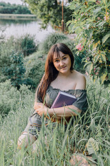 In combination with nature and flowers, harmony with oneself, happy moments, peace and balance. A charming girl in nature.
