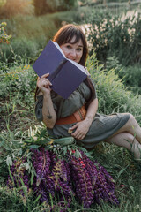 In combination with nature and flowers, harmony with oneself, happy moments, peace and balance. A charming girl in nature.