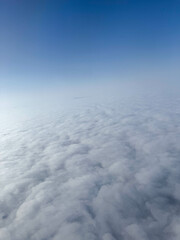 Deep blue sky meeting soft white clouds on the horizon