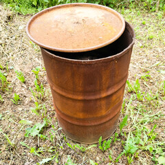 Rusty metal barrel with lid.