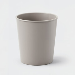 Grey plastic trash bin on light background