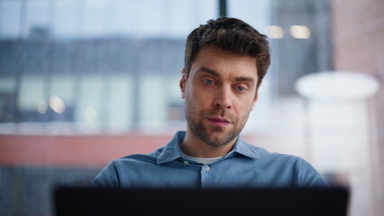 Serious entrepreneur closing laptop after online work closeup. Tired businessman