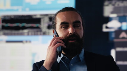 Businessman answering a smartphone call to evaluate digital analytics and corporate insight....