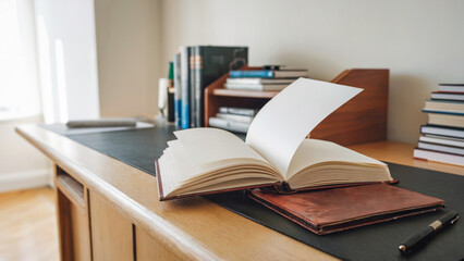 Open book with blank pages on a wooden desk, nobody