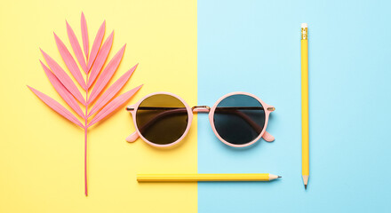 Pink palm leaf sunglasses and yellow pencils on a split yellow and blue background
