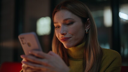 Woman messaging smartphone dark apartment closeup. Portrait business lady