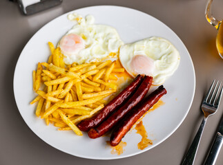 Scrambled eggs with sausage and potatoes. Spanish cuisine