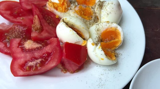 boiled eggs with black pepper and tomatoes delicious pique macho is a Bolivian dish consist of marinated beef with fried fried topped with fresh tomato, onions and egg