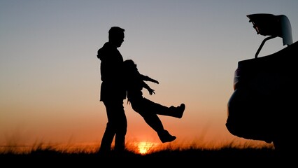 Baby girl flies in parent arms. Father little child play, laugh, rejoice together. Dad plays with child daughter, spinning baby holding hands in park in summer. Happy family walk. Happy family holiday