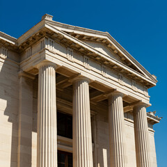 Naklejka premium Close-up view of a classical building with prominent columns and a triangular pediment.