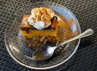 Piece of sweet chocolate grandma's cake served with whipped cream for dessert
