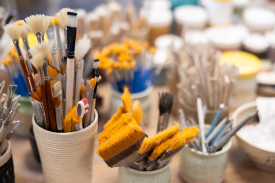 Close-up of brushes and tools for making ceramics in ceramic workshop