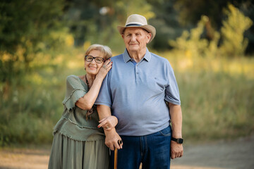Happy elderly people walking in the park on a sunny day