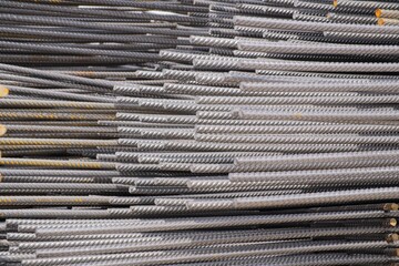 side view of Stacked ribbed steel bars create a textured metallic backdrop, highlighting essential...