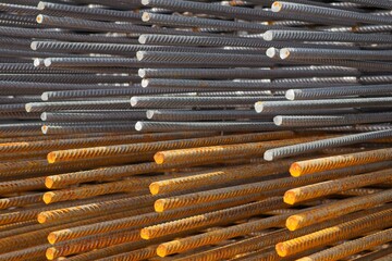 Close up of ribbed steel bars, highlighting the contrast between new and oxidized metal,...