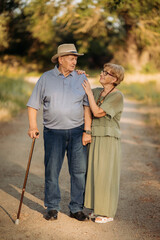 Happy elderly people walking in the park on a sunny day