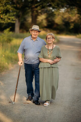 Happy elderly people walking in the park on a sunny day