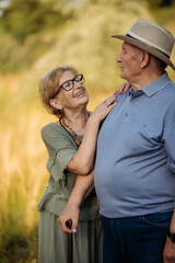 Happy elderly people walking in the park on a sunny day