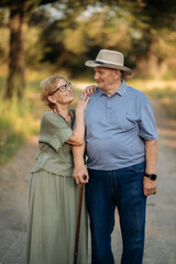 Happy elderly people walking in the park on a sunny day