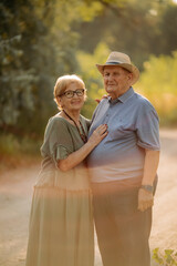 Happy elderly people walking in the park on a sunny day