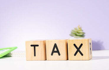 TAX Wooden Cubes On The Table – Financial Obligation Concept