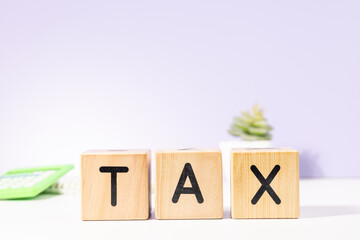 TAX Wooden Cubes On The Table – Financial Obligation Concept