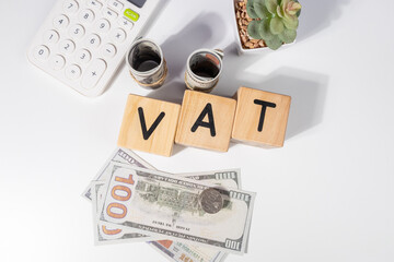 VAT Wooden Cubes with Cash and Calculator – Taxation Concept