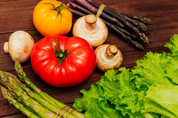 Fresh vegetables arranged on wooden surface for healthy meal preparation during afternoon