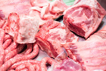 Butcher. Different types of organic meat. Beef assortment. Meat classification, nutritional aspects. Sausage, pork ribs, coppa, loin, pork