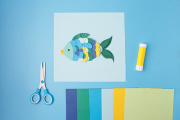 Colorful paper fish craft with glue and scissors for kids education visuals, DIY brands, learning materials, classroom art posters, toy design, and homeschooling activity publishers.